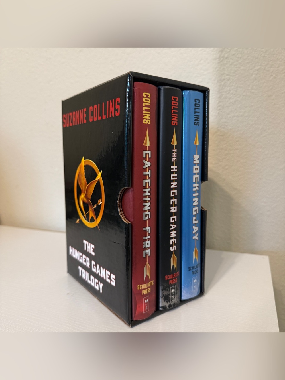 The Hunger Games Trilogy Box Set by Suzanne Collins - Red/Black/Blue spines